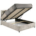 Beige Reeves upholstered full lift-top storage platform bed with padded headboard and wooden frame, featuring clean, modern furniture design.