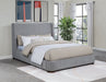 Grey Rennes upholstered Eastern king wingback platform bed by CoasterEveryday featuring a plush headboard and sturdy wooden frame.
