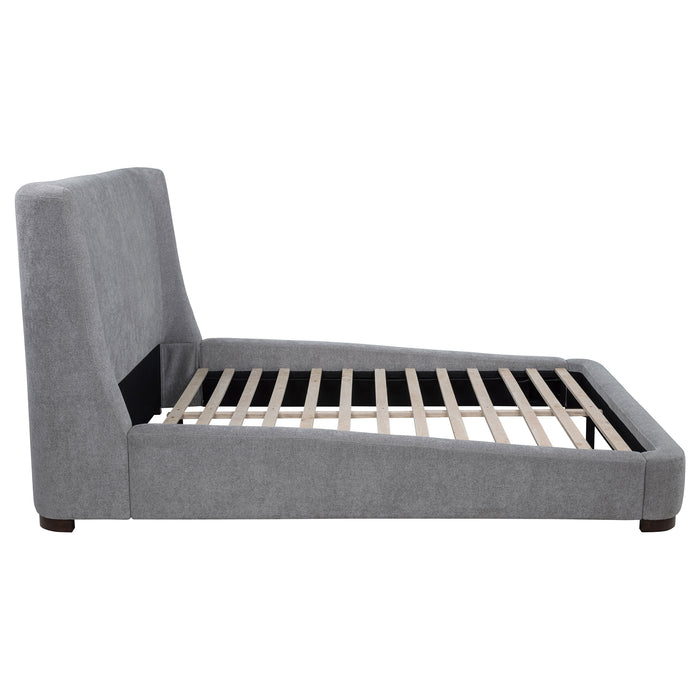Grey Rennes upholstered Eastern King wingback platform bed by CoasterEveryday with padded headboard and sleek wooden legs.