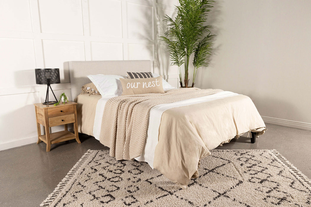 CoasterEveryday Pirro upholstered king panel headboard in soft sand fabric, showcasing its padded, stylish design for bedroom furniture.