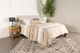 CoasterEveryday Pirro upholstered king panel headboard in soft sand fabric, showcasing its padded, stylish design for bedroom furniture.