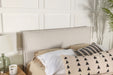 CoasterEveryday Izzy upholstered queen or full panel headboard in soft sand fabric, showcasing a stylish, padded furniture design.