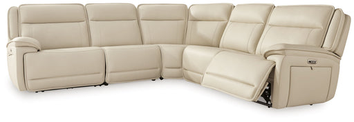 Signature Design by Ashley 5-piece reclining sectional sofa set with plush cushions and modern fabric in a spacious living room setting.
