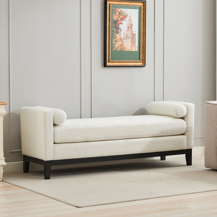 Elegant ivory boucle upholstered bench with wood legs and bolster pillows, serving as a daybed or ottoman by Giga.