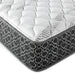 CoasterEveryday Hayes California King firm hybrid mattress with tight top in white, shown on a bedroom bed.