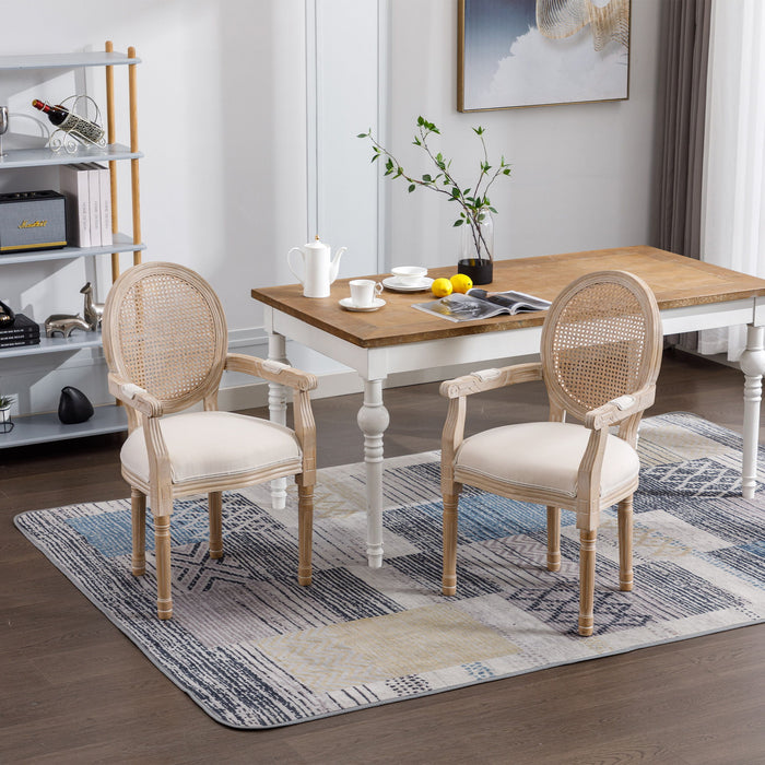 Set of two Giga French vintage beige upholstered fabric dining armchairs with elegant armrests and classic design.