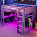 Gray Giga full size gaming loft bed with desk, storage shelves, LED lighting, and hanging clothes rack in a modern bedroom setting.