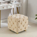 Giga upholstered ottoman with soft fabric, serving as a small end table or footstool in living room or bedroom decor.