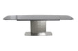 Contemporary black extendable dining table by Chintaly with textured glass top and stainless steel base, perfect for modern dining spaces.