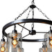HomeRoots black metal chandelier with six transparent glass shades and shaded metal accents, modern lighting fixture for ceilings.
