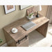Giga home office desk in hazelnut with one cabinet, three shelves, faux barn door, metal hinges, and light brown finish.