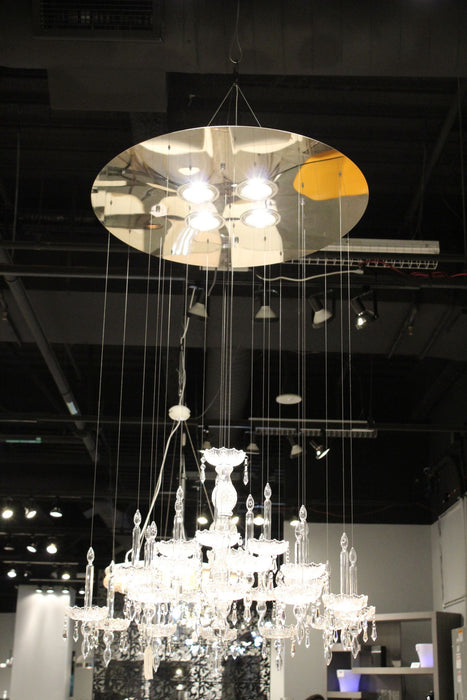 HomeRoots chandelier with four candle-style metal and glass lights, featuring nickel, ivory, and clear glass accents.
