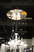 HomeRoots chandelier with four candle-style metal and glass lights, featuring nickel, ivory, and clear glass accents.
