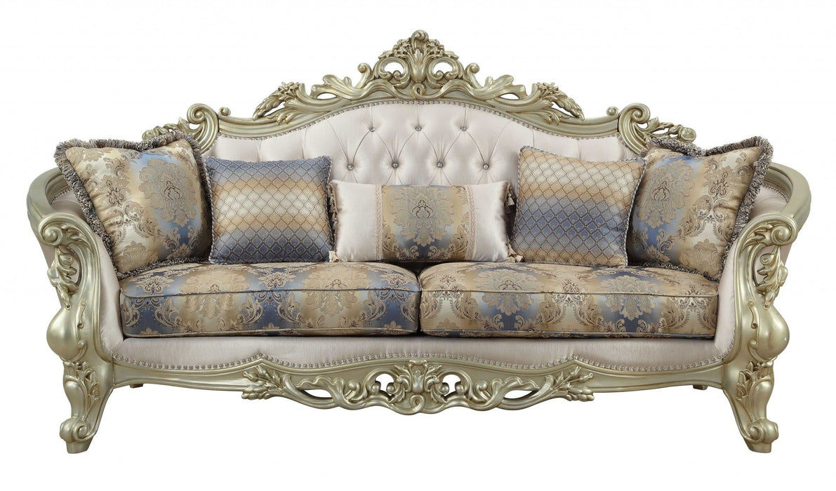 Velvet curved floral sofa with champagne legs and matching toss pillows in antiqued white, styled as a stationary sofa by HomeRoots.