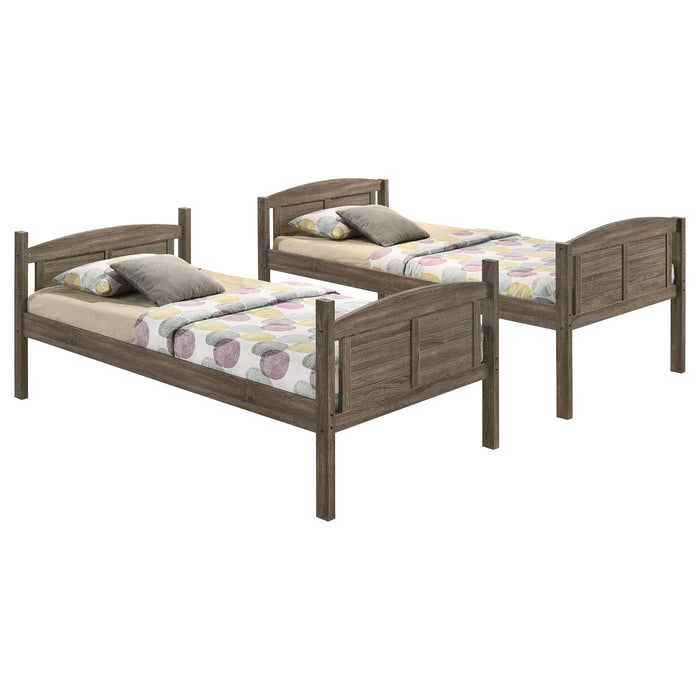 Weathered brown Flynn wood twin over twin bunk bed with mattress, showcasing a sturdy furniture piece with a natural finish.