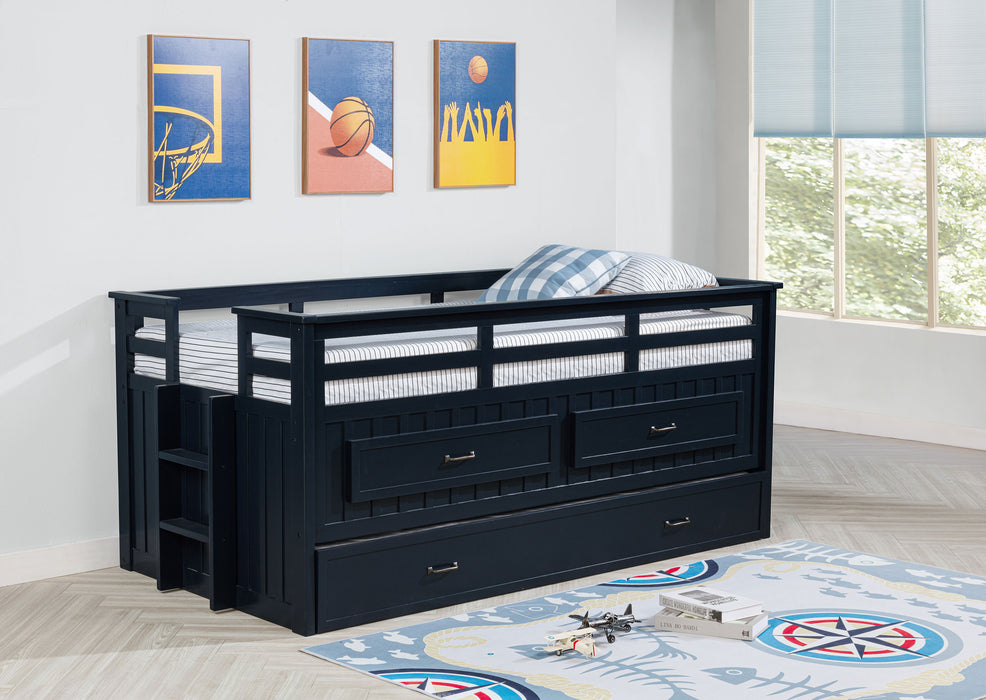 Carlsbad Wood Twin Captains Bed with Trundle in navy blue, showcasing the sturdy wooden frame and built-in storage drawers.