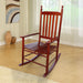 Giga wooden porch rocker chair with curved armrests and slatted backrest, perfect for outdoor relaxation on a porch.