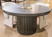 Black Haldenwick round dining room table by Signature Design Ashley, showcasing a sleek, modern dining surface with sturdy legs.