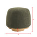 Giga round soft teddy fabric upholstered ottoman with metal accents, serving as a stylish stool or footrest.