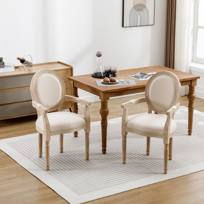 Set of two Giga French vintage upholstered fabric dining armchairs with classic design and cushioned seats.