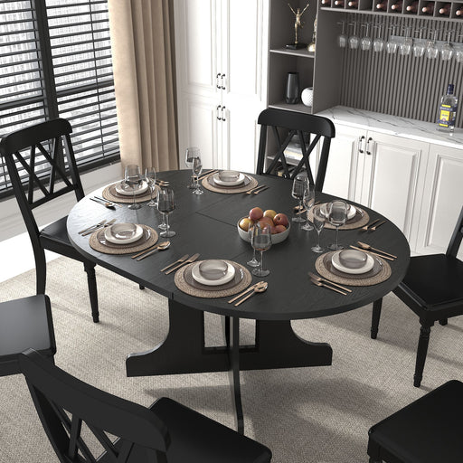 Black Giga farmhouse dining table with oval top, expandable with removable leaf, trestle X-shaped base, suitable for kitchen use.