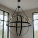 Black and gold 56-inch candle style twelve-light metal chandelier with dimmable features, designed by HomeRoots.