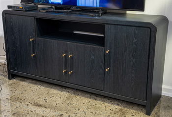 Black large TV stand from Signature Design by Ashley® featuring spacious shelves and modern design for living room entertainment.