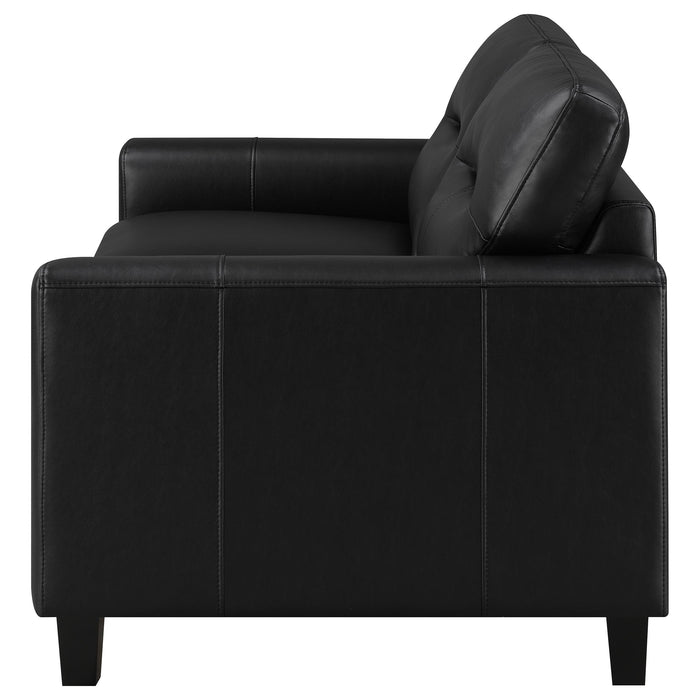 Black Scotland faux leather upholstered track arm loveseat by CoasterEveryday, showcasing plush cushions and sleek modern design.