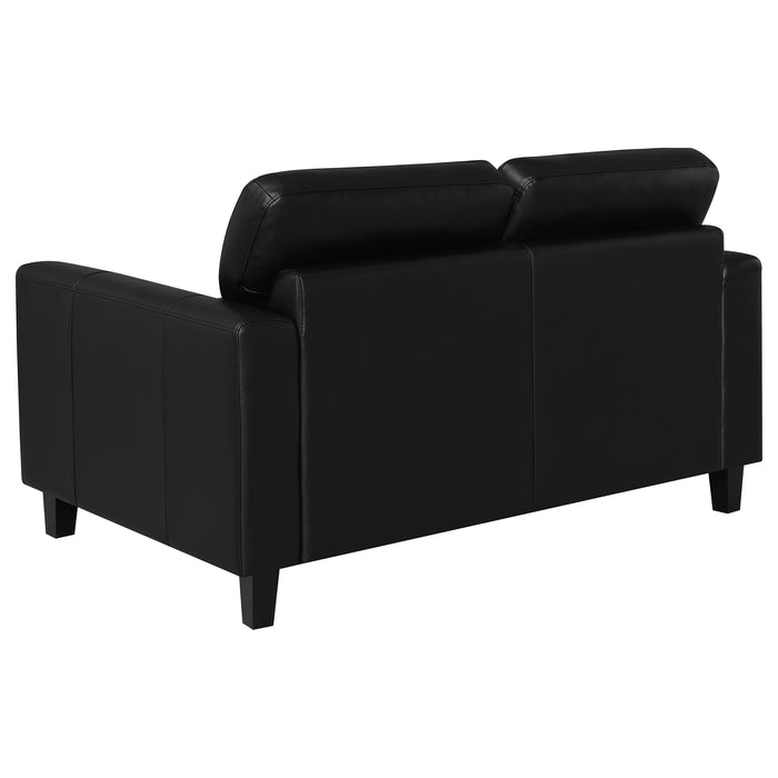 Black Scotland faux leather upholstered track arm loveseat from CoasterEveryday, featuring plush cushions and modern furniture design.