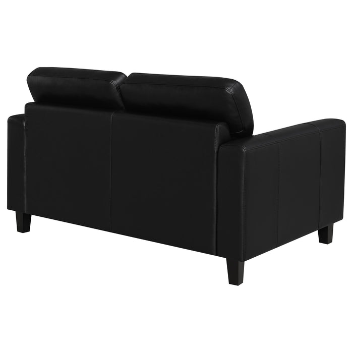 Black Scotland faux leather upholstered track arm loveseat by CoasterEveryday, showcasing plush cushioning and sleek design.