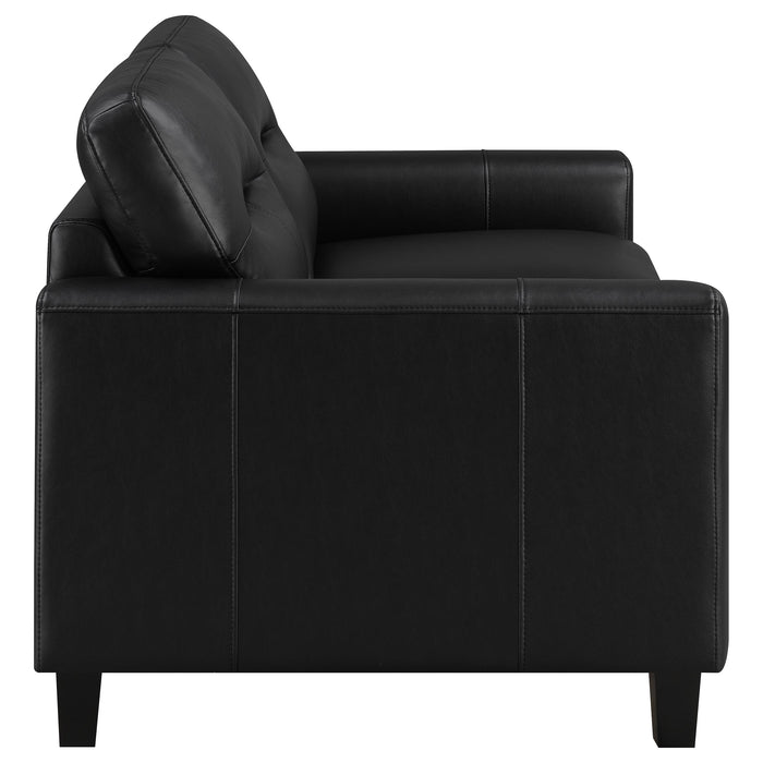 Black Scotland faux leather upholstered track arm loveseat by CoasterEveryday, showing plush seating and sleek modern design.