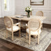Set of two Giga French vintage upholstered fabric dining armchairs in beige with elegant curved arms and button-tufted backs.