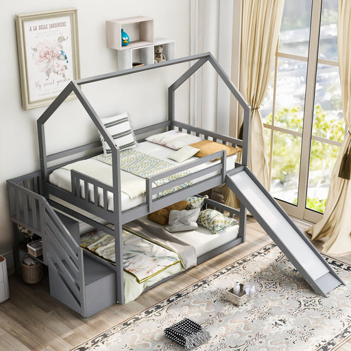 Giga twin over twin house bunk bed with convertible slide, storage staircase, and built-in drawers in a modern children's bedroom.