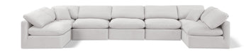 Velvet Meridian Furniture Indulge 7-Piece Modular U-Shaped Sectional sofa with plush cushions and modern design in a living room setting.