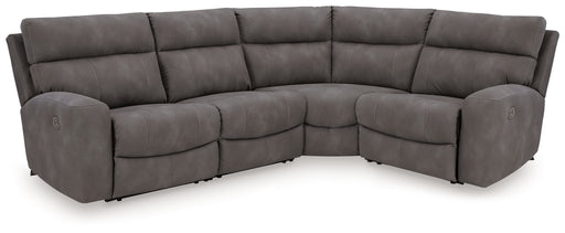 Signature Design by Ashley Durapella 4-piece reclining sectional with plush cushions and reclining seats in a modern living room setting.