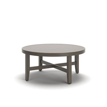 Point Sur round cocktail table in beige and brown by Millennium by Ashley