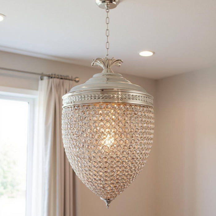 HomeRoots silver three-light metal and crystal glass chandelier with shades, featuring a modern statement design with elegant crystal accents.