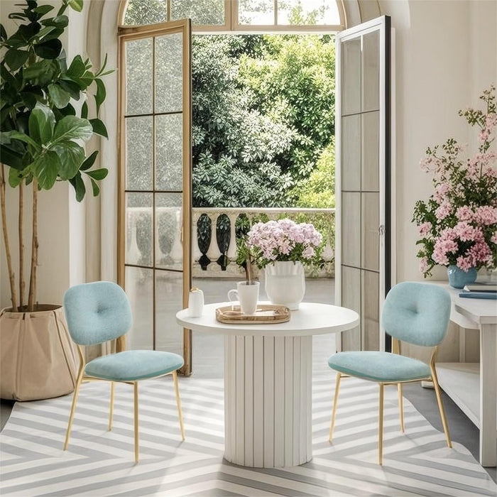 Set of two Giga modern dining chairs with green upholstered seats, metal legs, space-saving contemporary design