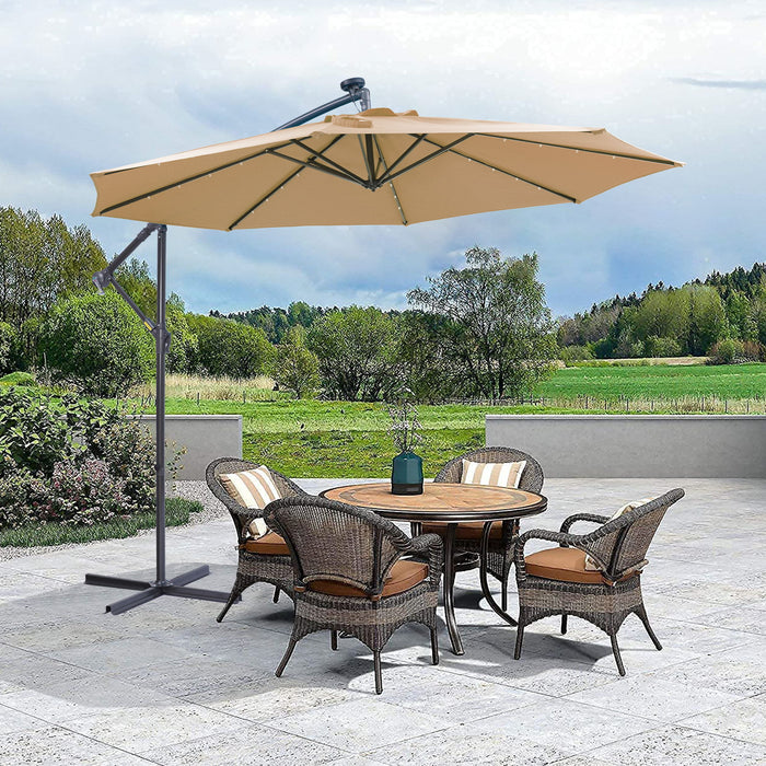 Giga 10 ft outdoor cantilever patio umbrella with taupe fabric, LED lights, metal frame, and easy open adjustment in a backyard setting.