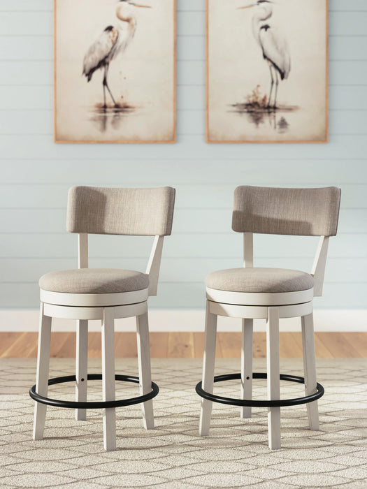 Two Signature Design by Ashley Robbinsdale upholstered swivel barstools in antique white with wooden legs, set of 2.