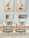 Two Signature Design by Ashley Robbinsdale upholstered swivel barstools in antique white with wooden legs, set of 2.