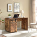 Giga home office desk with one cabinet, three shelves, faux barn door, metal hinges, and distressed wood finish.