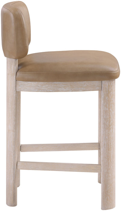 Set of two Meridian Furniture Paloma vegan leather counter stools in tan with upholstered seats and dark wooden legs.