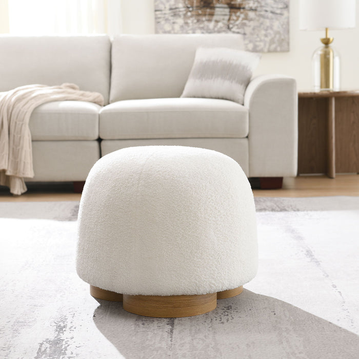 Giga round soft teddy fabric upholstered ottoman with metal accents, serving as a stylish stool or footrest.