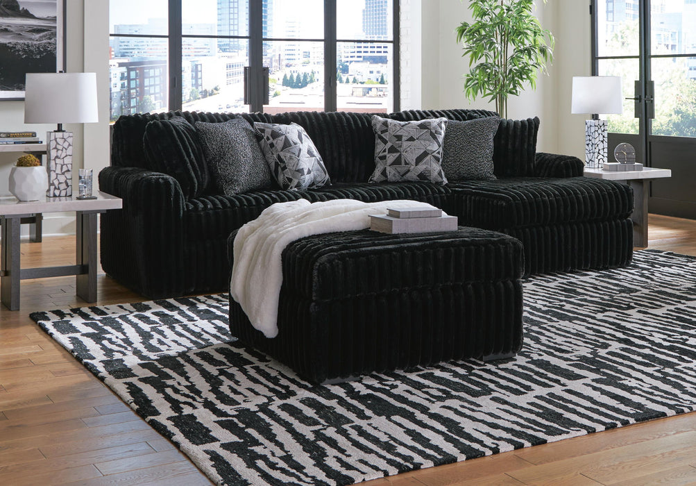 Signature Design by Ashley Midnight Madness stationary sectional with plush cushions and modern fabric, perfect for living room seating.