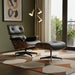 Black tufted leather swivel lounge chair with matching ottoman by HomeRoots, featuring a stylish and comfortable stationary design.
