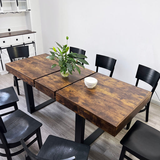 Modern rustic brown Giga extendable dining table with seating for 6 to 10, featuring a long, spacious wooden design.