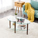 Giga transparent oval glass coffee table with oak wood legs and three-layer design in a modern living room setting