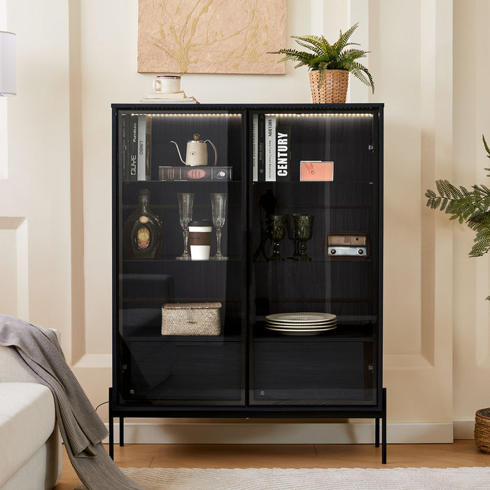 Giga modern minimalist LED display cabinet with tempered glass door and metal legs, showcasing interior shelves and lighting.