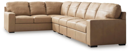 Signature Design by Ashley Bandon 4-piece stationary sectional sofa with plush cushions and modern design, shown in a living room setting.